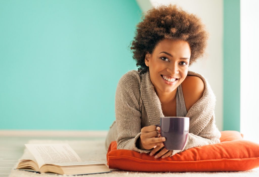 woman relaxing on the floor with a mug